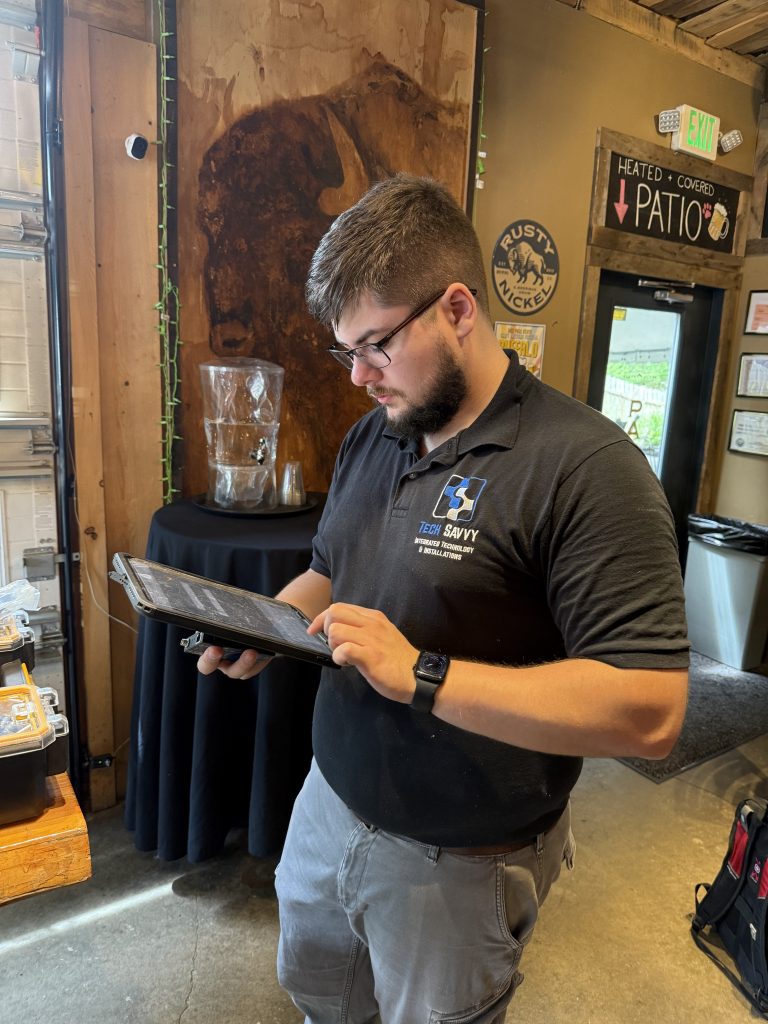 Expert AV technician working on Ipad